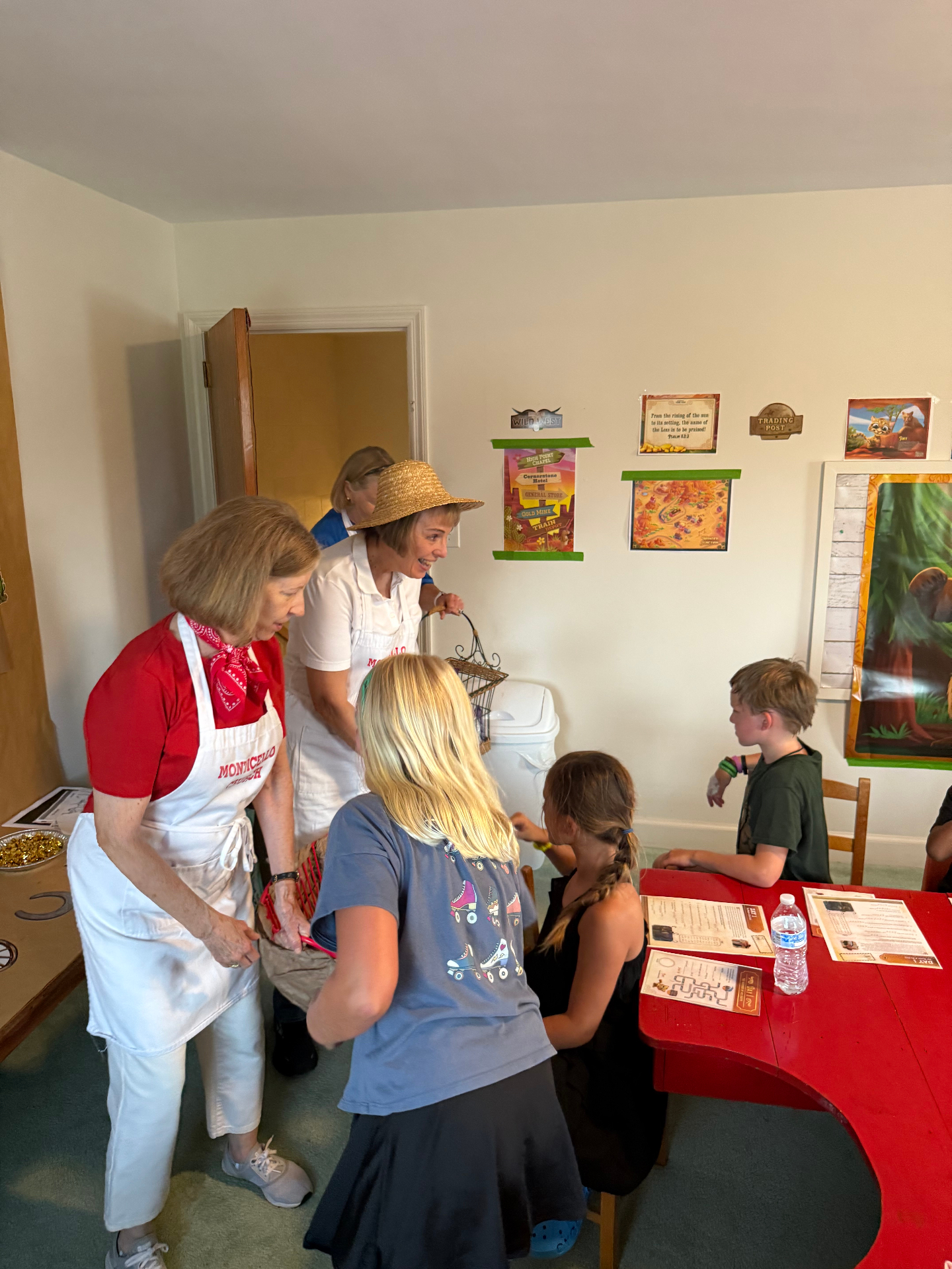 Volunteers welcoming children at a Monticello church gathering