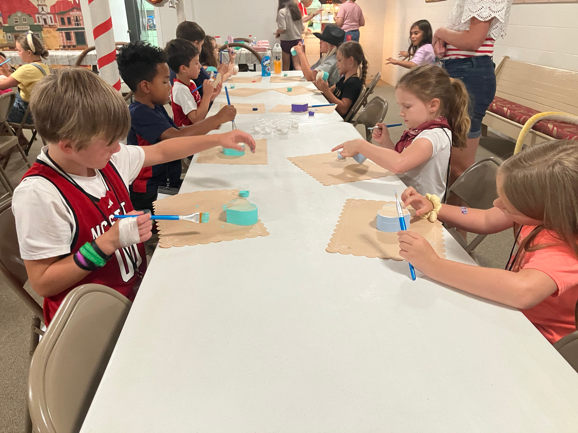 Kids painting crafts together at a church event